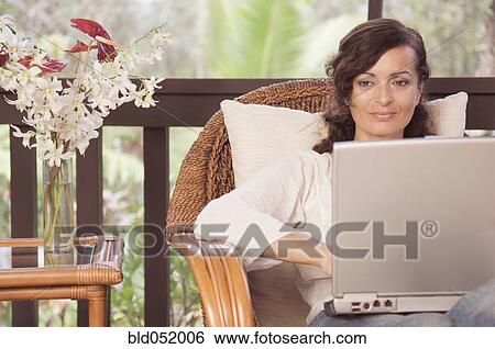 Mature woman typing on laptop View Large Photo Image Stock Photograph - Mature woman typing on laptop. Fotosearch