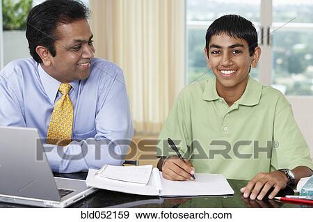 Middle Eastern father helping son with homework View Large Photo Image Stock Photo - Middle Eastern father helping son with homework. Fotosearch