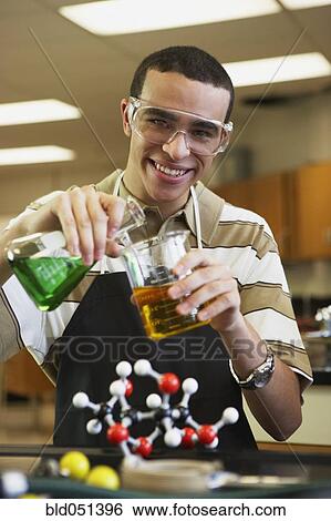 Stock Photograph - Mixed Race teenaged boy in science class. Fotosearch