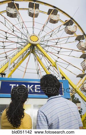 Stock Image - Mixed Race teenaged couple at carnival. Fotosearch
