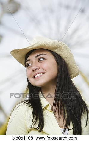 Stock Photo - Mixed Race teenaged girl wearing cowboy hat. Fotosearch