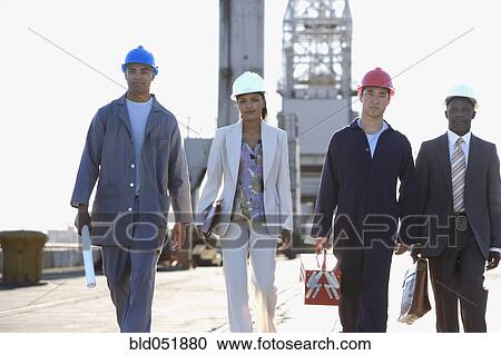 Multi-ethnic businesspeople and construction workers walking View Large Photo Image Stock Image - Multi-ethnic businesspeople and construction workers walking. Fotosearch