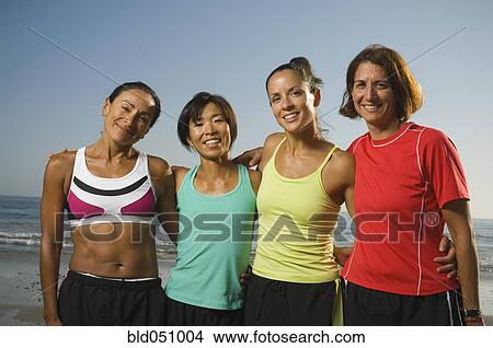 Picture - Multi-ethnic female runners at beach. Fotosearch