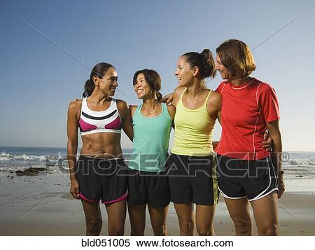 Stock Photography - Multi-ethnic female runners at beach. Fotosearch
