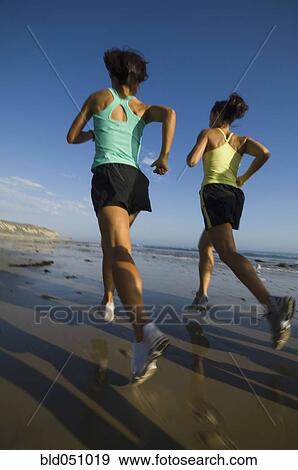 Multi-ethnic female runners racing at beach View Large Photo Image Stock Photo - Multi-ethnic female runners racing at beach. Fotosearch