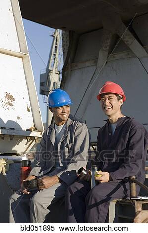 Multi-ethnic male construction workers drinking coffee View Large Photo Image Stock Photography - Multi-ethnic male construction workers drinking coffee. Fotosearch