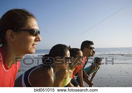 Stock Photography - Multi-ethnic runners racing at beach. Fotosearch