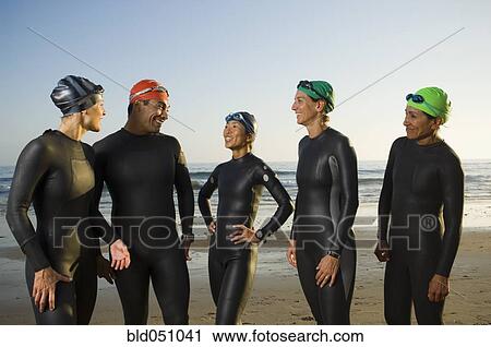 Multi-ethnic swimmers wearing wetsuits and goggles View Large Photo Image Stock Image - Multi-ethnic swimmers wearing wetsuits and goggles. Fotosearch