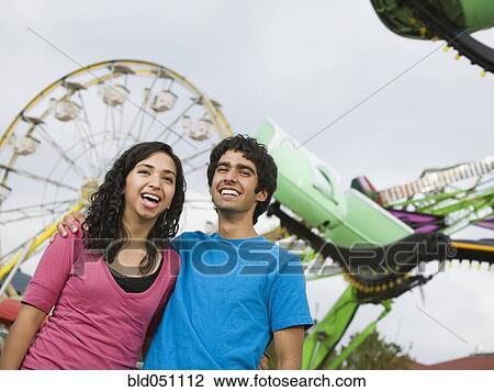 Stock Image - Multi-ethnic teenaged couple at carnival. Fotosearch
