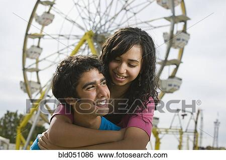 Multi-ethnic teenaged couple at carnival View Large Photo Image Stock Photograph - Multi-ethnic teenaged couple at carnival. Fotosearch