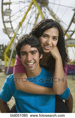 Stock Photography - Multi-ethnic teenaged couple at carnival. Fotosearch