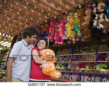 Stock Photo - Multi-ethnic teenaged couple at carnival . Fotosearch