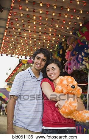 Multi-ethnic teenaged couple at carnival View Large Photo Image Stock Photograph - Multi-ethnic teenaged couple at carnival . Fotosearch