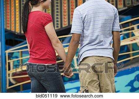 Stock Photo - Multi-ethnic teenaged couple holding hands. Fotosearch