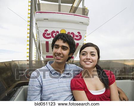 Multi-ethnic teenaged couple on carnival ride View Large Photo Image Stock Image - Multi-ethnic teenaged couple on carnival ride. Fotosearch
