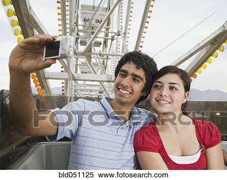 Multi-ethnic teenaged couple on carnival ride View Large Photo Image Stock Photography - Multi-ethnic teenaged couple on carnival ride. Fotosearch