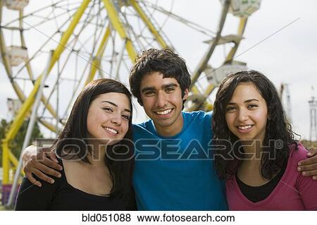 Multi-ethnic teenaged friends at carnival View Large Photo Image Stock Photo - Multi-ethnic teenaged friends at carnival. Fotosearch