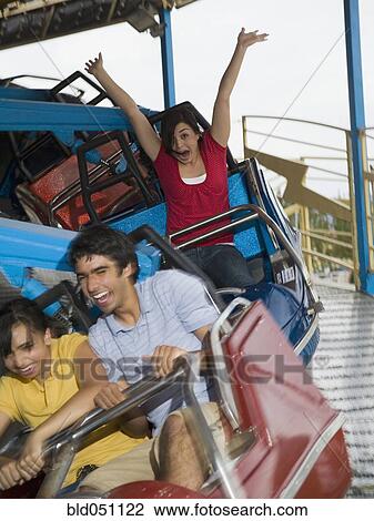 Multi-ethnic teenaged friends on carnival ride View Large Photo Image Stock Image - Multi-ethnic teenaged friends on carnival ride. Fotosearch