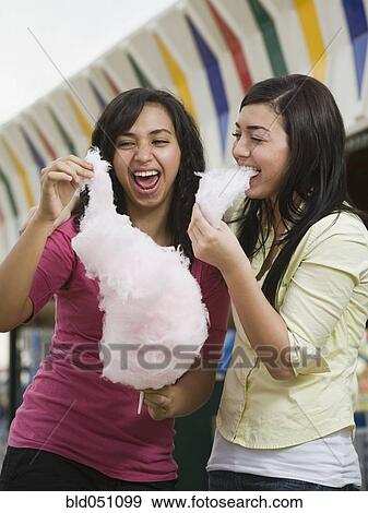 Multi-ethnic teenaged girls eating cotton candy View Large Photo Image Stock Photo - Multi-ethnic teenaged girls eating cotton candy. Fotosearch
