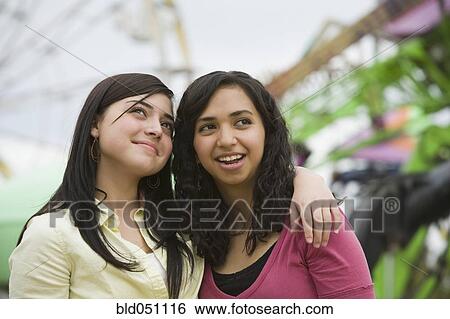 Multi-ethnic teenaged girls hugging View Large Photo Image Stock Photograph - Multi-ethnic teenaged girls hugging. Fotosearch