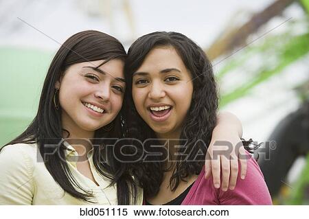 Multi-ethnic teenaged girls hugging View Large Photo Image Stock Photography - Multi-ethnic teenaged girls hugging. Fotosearch