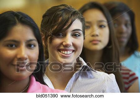 Stock Image - Multi-ethnic teenaged girls in row. Fotosearch
