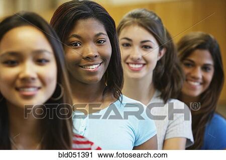 Stock Image - Multi-ethnic teenaged girls in row. Fotosearch