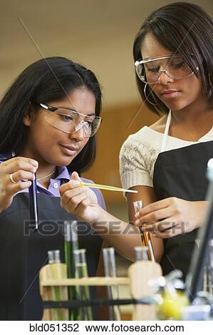 Stock Image - Multi-ethnic teenaged girls in science class. Fotosearch