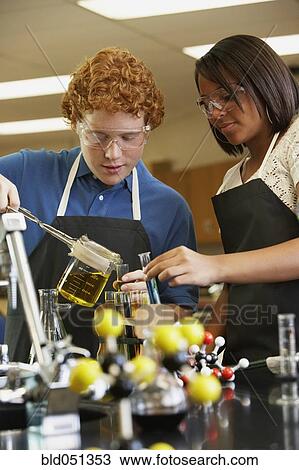 Stock Image - Multi-ethnic teenagers in science class. Fotosearch