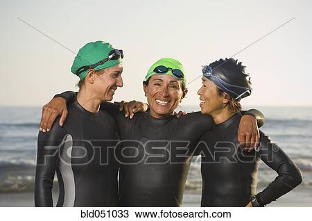 Multi-ethnic women wearing wetsuits and goggles View Large Photo Image Stock Image - Multi-ethnic women wearing wetsuits and goggles. Fotosearch