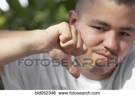 Pacific Islander man giving thumbs down View Large Photo Image Stock Photograph - Pacific Islander man giving thumbs down. Fotosearch