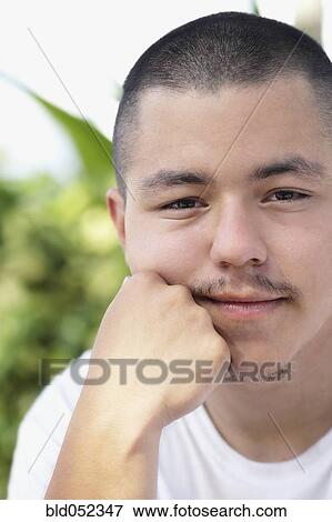 Pacific Islander man resting chin on hand View Large Photo Image Stock Photo - Pacific Islander man resting chin on hand. Fotosearch