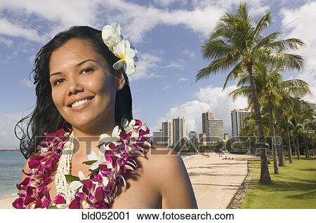 Stock Image - Pacific Islander woman wearing lei. Fotosearch