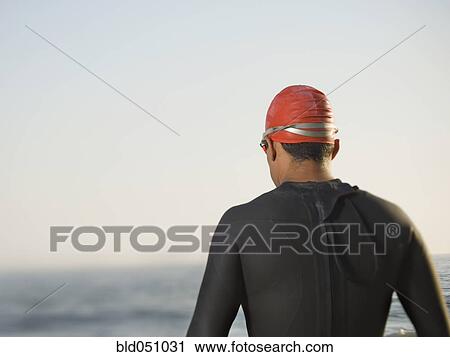 Rear view of Hispanic man wearing wetsuit View Large Photo Image Stock Image - Rear view of Hispanic man wearing wetsuit. Fotosearch