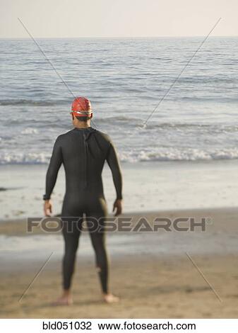 Rear view of Hispanic man wearing wetsuit View Large Photo Image Stock Image - Rear view of Hispanic man wearing wetsuit. Fotosearch