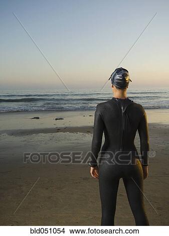 Rear view of Hispanic woman wearing wetsuit View Large Photo Image Picture - Rear view of Hispanic woman wearing wetsuit. Fotosearch