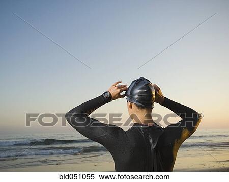 Rear view of Hispanic woman wearing wetsuit View Large Photo Image Stock Photography - Rear view of Hispanic woman wearing wetsuit. Fotosearch