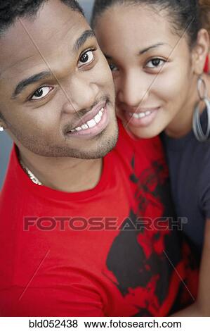 Stock Photo - Young African couple hugging. Fotosearch