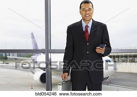 Stock Photograph - African businessman at airport. Fotosearch