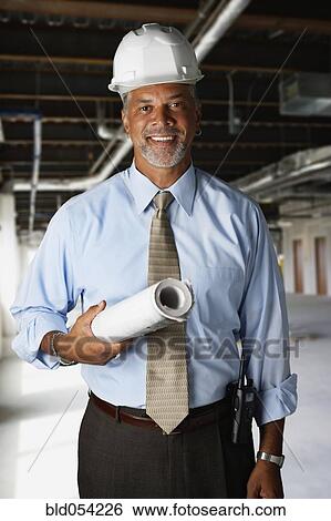 African businessman wearing hard hat View Large Photo Image Stock Photograph - African businessman wearing hard hat. Fotosearch