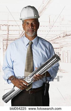 Stock Photography - African businessman wearing hard hat. Fotosearch