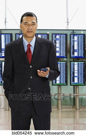 Stock Photography - African businessman with hand in pocket. Fotosearch