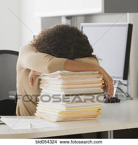 African businesswoman leaning on stack of paperwork View Large Photo Image Picture - African businesswoman leaning on stack of paperwork. Fotosearch