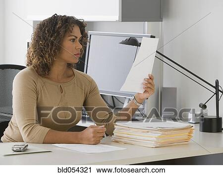 African businesswoman reading paperwork View Large Photo Image Stock Image - African businesswoman reading paperwork. Fotosearch