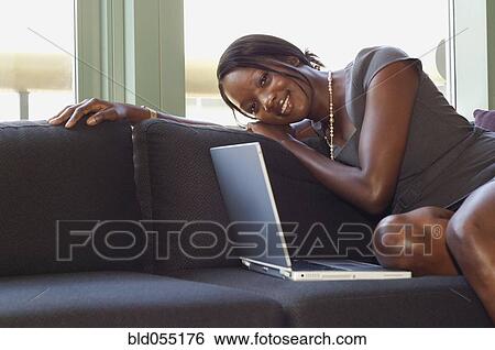 African businesswoman sitting on sofa View Large Photo Image Stock Photograph - African businesswoman sitting on sofa. Fotosearch