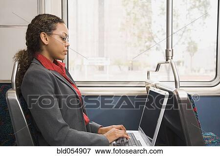 Stock Photo - African businesswoman working on train. Fotosearch