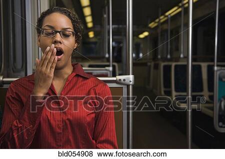 African businesswoman yawning on train View Large Photo Image Stock Photo - African businesswoman yawning on train. Fotosearch