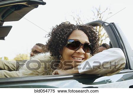 African couple driving in convertible car View Large Photo Image Stock Photography - African couple driving in convertible car. Fotosearch