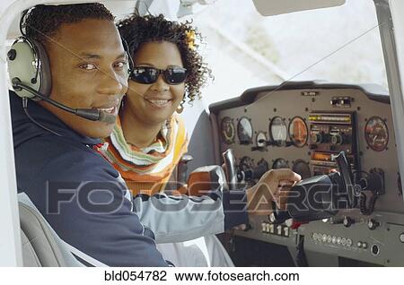 Stock Image - African couple in cockpit of airplane. Fotosearch