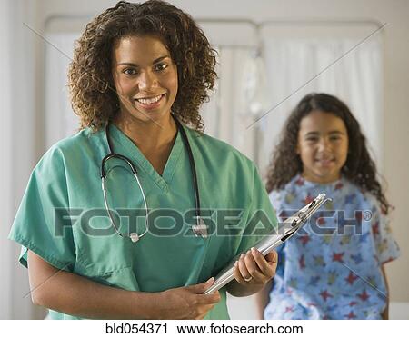 Stock Image - African female doctor holding chart. Fotosearch